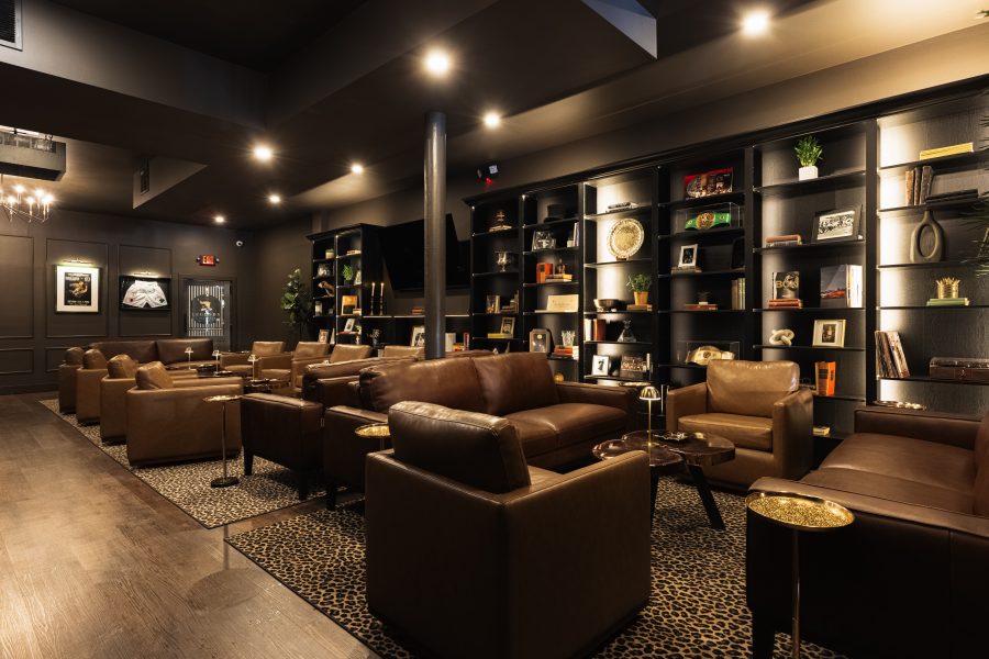 The lounge, with leather seating and lit shelving